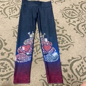 Justice leggings with “poop” emoji